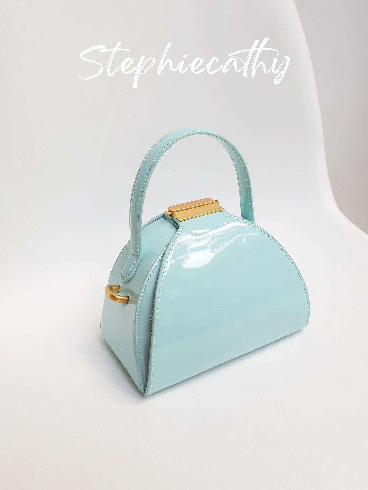 Curved Lock Crossbody Bag
